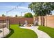 Backyard firepit with Adirondack chairs on artificial turf, great for outdoor living at 13709 W Rovey Ave, Litchfield Park, AZ 85340