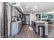 Updated kitchen features gray cabinets, stainless steel appliances, and a spacious island at 13709 W Rovey Ave, Litchfield Park, AZ 85340
