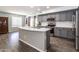 Beautiful kitchen with gray cabinets, stainless steel appliances, and a center island with ample counter space at 13709 W Rovey Ave, Litchfield Park, AZ 85340