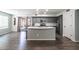 Modern kitchen features stainless steel appliances, gray cabinetry, and a spacious island with seating at 13709 W Rovey Ave, Litchfield Park, AZ 85340