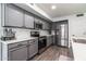 Modern kitchen with stainless appliances, sleek grey cabinetry, and a bright design for everyday cooking needs at 13709 W Rovey Ave, Litchfield Park, AZ 85340