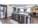 Well-equipped kitchen with gray cabinetry, stainless steel appliances, and an island for food preparation and casual dining at 13709 W Rovey Ave, Litchfield Park, AZ 85340