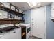 Bright laundry room with modern washer and dryer and stylish shelving at 13709 W Rovey Ave, Litchfield Park, AZ 85340