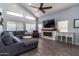 Spacious living room boasting tall ceilings, wood floors, and a cozy fireplace at 13709 W Rovey Ave, Litchfield Park, AZ 85340