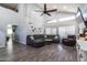 Bright living room featuring vaulted ceilings, large windows, and a comfortable sectional sofa at 13709 W Rovey Ave, Litchfield Park, AZ 85340
