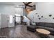Spacious living room featuring high ceilings, modern decor, and an open floor plan that is perfect for entertaining at 13709 W Rovey Ave, Litchfield Park, AZ 85340