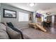 Comfortable living area with a large couch, natural light, and access to the dining area, ideal for relaxation at 13709 W Rovey Ave, Litchfield Park, AZ 85340