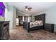 Spacious main bedroom with ceiling fan, ensuite, and neutral tones at 13709 W Rovey Ave, Litchfield Park, AZ 85340