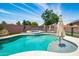Sparkling backyard pool and spa featuring an umbrella stand, ideal for relaxation and fun at 13709 W Rovey Ave, Litchfield Park, AZ 85340