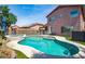 Inviting backyard pool and spa area with well-maintained landscaping and privacy fence at 13709 W Rovey Ave, Litchfield Park, AZ 85340