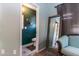 Sitting room with muted aqua walls and accent furniture next to a door to a half bath at 13709 W Rovey Ave, Litchfield Park, AZ 85340