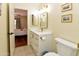 Bright bathroom featuring a white vanity with gold fixtures and view of the bedroom at 14910 N Kings Way # 105, Fountain Hills, AZ 85268