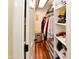 Walk-in closet featuring hanging clothes, shelves, drawers and wood floor at 14910 N Kings Way # 105, Fountain Hills, AZ 85268