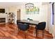 Open concept dining room featuring fireplace, hardwood floors, and modern decor at 14910 N Kings Way # 105, Fountain Hills, AZ 85268