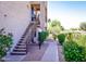 Two-story building exterior featuring exterior stairwell, gravel yard, and walkway at 14910 N Kings Way # 105, Fountain Hills, AZ 85268