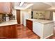 Open kitchen concept featuring hardwood floors and tile backsplash that looks into the living room at 14910 N Kings Way # 105, Fountain Hills, AZ 85268