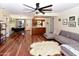 Inviting living room with a fan, hardwood floors, grey sofa and view to kitchen and dining area at 14910 N Kings Way # 105, Fountain Hills, AZ 85268