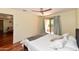 Comfortable main bedroom featuring hardwood floors, sliding glass door to the balcony and view of the living area at 14910 N Kings Way # 105, Fountain Hills, AZ 85268