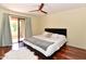 Comfortable main bedroom featuring hardwood floors, and sliding glass door to the balcony at 14910 N Kings Way # 105, Fountain Hills, AZ 85268