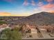 Stunning aerial view of a desert home with a mountain backdrop and vibrant sunset skies, and tile roof at 15232 S 36Th Pl, Phoenix, AZ 85044