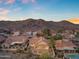 Sunset aerial of a desert community featuring tile roofs and mountain views at 15232 S 36Th Pl, Phoenix, AZ 85044