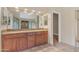 Bathroom vanity features wood cabinets, double sinks, and granite counters at 15232 S 36Th Pl, Phoenix, AZ 85044