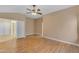 Bedroom features neutral walls, ceiling fan, and adjoining bathroom at 15232 S 36Th Pl, Phoenix, AZ 85044