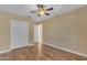 Bright bedroom with wooden floors, closet with double doors, and ceiling fan at 15232 S 36Th Pl, Phoenix, AZ 85044