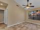The bedroom features neutral walls, a ceiling fan, and large window at 15232 S 36Th Pl, Phoenix, AZ 85044