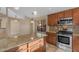 Modern kitchen with granite countertops, stainless steel appliances, and adjacent dining area at 15232 S 36Th Pl, Phoenix, AZ 85044
