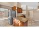 Bright kitchen boasts a granite island, stainless fridge, and complementary cabinets at 15232 S 36Th Pl, Phoenix, AZ 85044