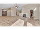 Open-concept living room with tile flooring, fireplace, and access to the kitchen and dining areas at 15232 S 36Th Pl, Phoenix, AZ 85044