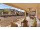 Covered patio with comfortable seating and views of the natural landscaping at 15232 S 36Th Pl, Phoenix, AZ 85044