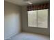 Neutral bedroom features a ceiling fan and window with blinds at 15314 W Camino Estrella Dr, Surprise, AZ 85374