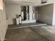 Clean garage with a water heater and cabinets at 15314 W Camino Estrella Dr, Surprise, AZ 85374