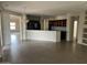 Open-concept living area with sightlines to a modern kitchen featuring granite countertops and dark wood cabinets at 15314 W Camino Estrella Dr, Surprise, AZ 85374