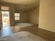 Inviting living space with tile flooring, neutral walls, and abundant natural light from the front door at 15314 W Camino Estrella Dr, Surprise, AZ 85374