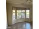 Inviting living room with bay windows offering natural light and views of the outdoor space at 15314 W Camino Estrella Dr, Surprise, AZ 85374