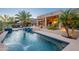 Scenic backyard features a pool with waterfall, patio area, and desert landscaping at 16333 E Crystal Point Dr, Fountain Hills, AZ 85268