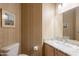 Charming half-bathroom with patterned wallpaper, granite countertop, and decorative wall art at 16333 E Crystal Point Dr, Fountain Hills, AZ 85268