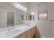 Bright bathroom featuring a double sink vanity with marble countertop, a mirror, and a shower-tub combo at 16333 E Crystal Point Dr, Fountain Hills, AZ 85268
