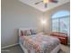 Cozy bedroom with a patterned quilt, arched window, and decorative wooden bench at 16333 E Crystal Point Dr, Fountain Hills, AZ 85268