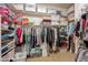 Organized walk-in closet featuring ample storage shelves, hanging racks, and neatly stored bins at 16333 E Crystal Point Dr, Fountain Hills, AZ 85268