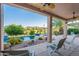 Inviting covered patio showcasing outdoor lounge area overlooking the pool and scenic backyard at 16333 E Crystal Point Dr, Fountain Hills, AZ 85268