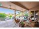 Relaxing covered patio with ample seating and a view of the backyard pool and desert landscape at 16333 E Crystal Point Dr, Fountain Hills, AZ 85268