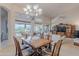 Open dining area with large windows, chandelier, and a wooden dining table set at 16333 E Crystal Point Dr, Fountain Hills, AZ 85268