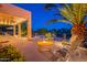 Inviting backyard with a cozy fire pit, lounge chairs, and an open patio space at 16333 E Crystal Point Dr, Fountain Hills, AZ 85268