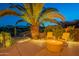 Comfortable backyard seating around a cozy fire pit and lush desert landscaping at 16333 E Crystal Point Dr, Fountain Hills, AZ 85268