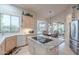 Well-lit kitchen with stainless steel appliances, granite countertops, and a breakfast bar at 16333 E Crystal Point Dr, Fountain Hills, AZ 85268