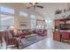 Inviting living room featuring vaulted ceilings, a ceiling fan, a comfortable sofa, and a view into the kitchen at 16333 E Crystal Point Dr, Fountain Hills, AZ 85268